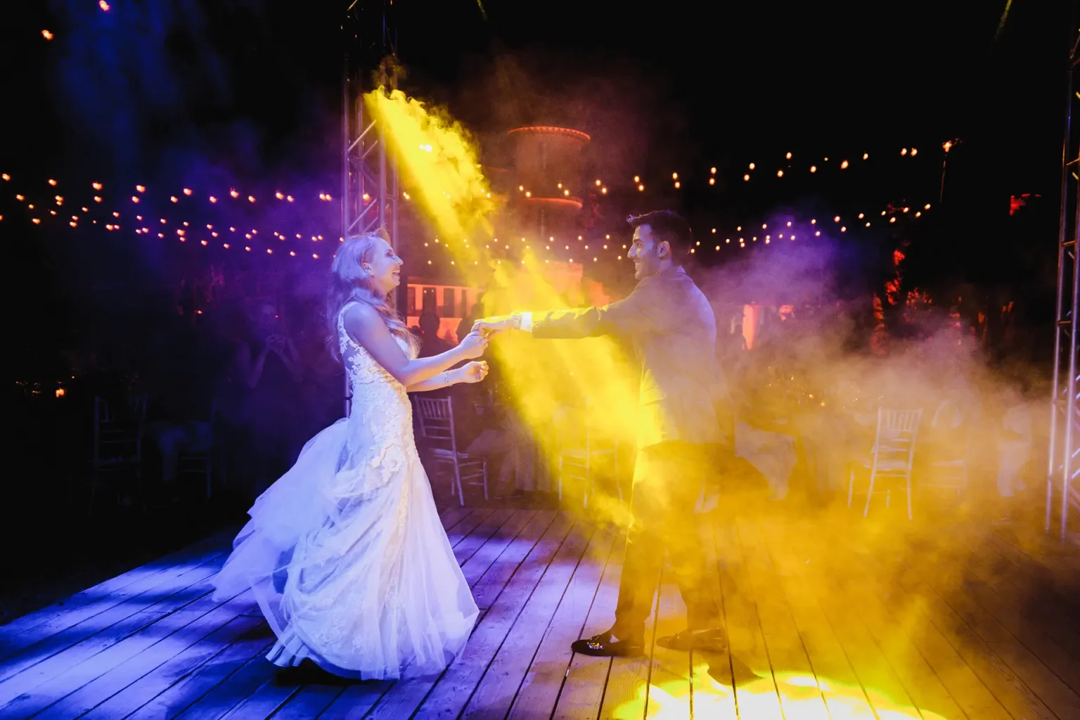 a man and woman dancing on a wooden floor